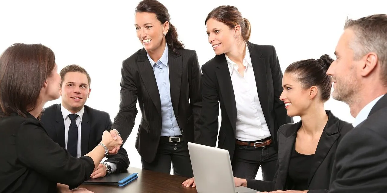 "Group of diverse people laughing together at a picnic."